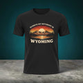 Wyoming Sunset Graphic T-Shirt by Big Sky Ranch Co. featuring mountain and sunset design with "Sunsets Hit Different in Wyoming" text.