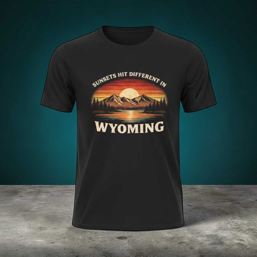 Wyoming Sunset Graphic T-Shirt by Big Sky Ranch Co. featuring mountain and sunset design with "Sunsets Hit Different in Wyoming" text.