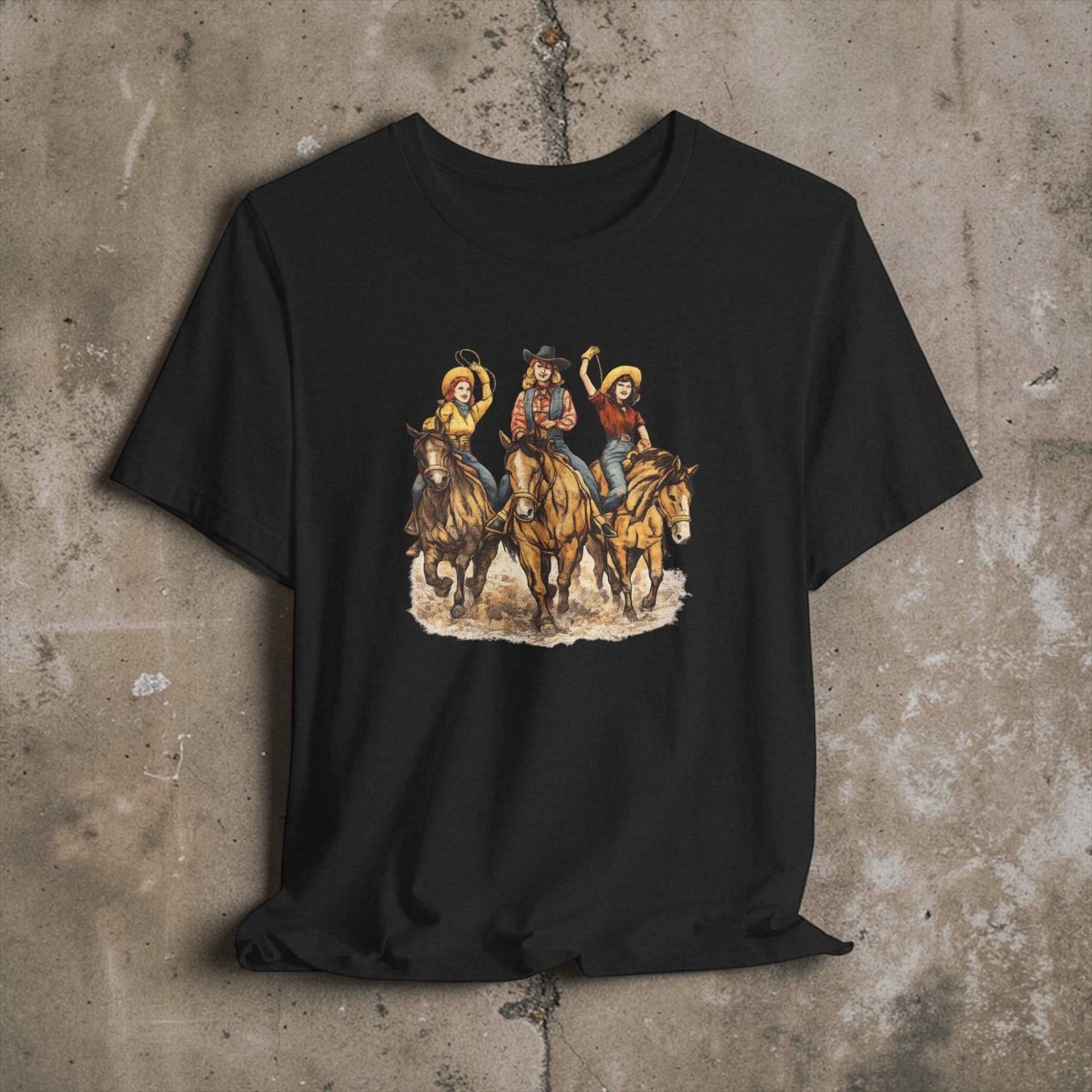Big Sky Ranch Co. Cowgirl Trio riding horses cowboy graphic T-shirt, Western rodeo style, casual Western-themed apparel.