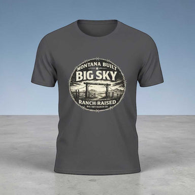 Big Sky Ranch T-shirt featuring the phrase “Montana Built, Ranch Raised” with a rugged ranch scene, cattle silhouettes, and a distressed vintage Western aesthetic
