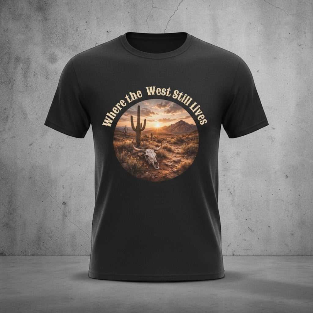 Western Sunset Tee by Big Sky Ranch Co. featuring a desert scene with a sunset and the phrase "Where the West Still Lives" on a T-shirt.