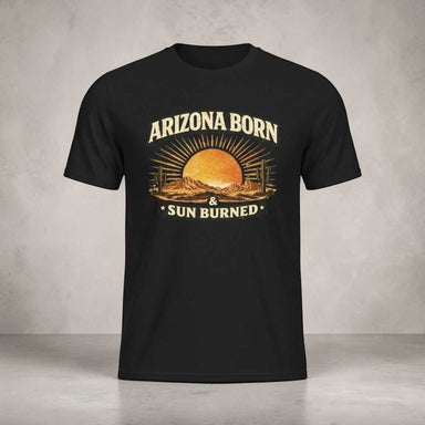 Arizona Born & Sun Burned T-shirt featuring a bold desert sunset with warm retro tones, cactus silhouettes, and a rugged, sun-faded vintage style